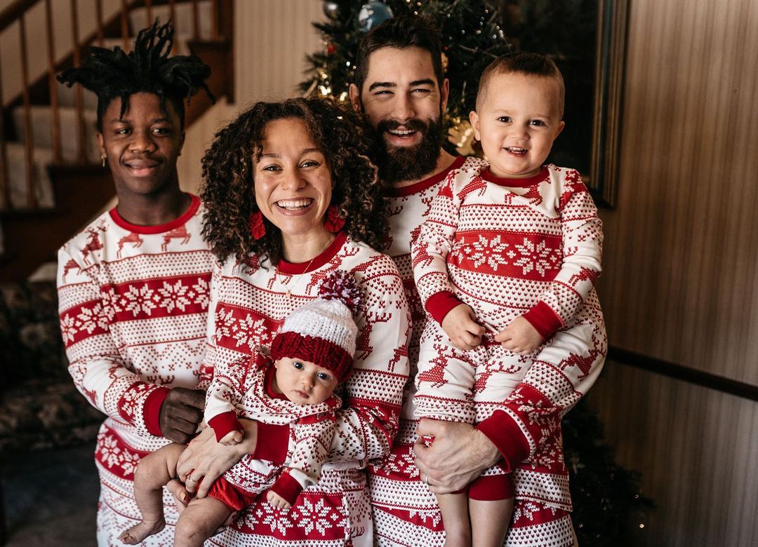 Matching family Christmas pajamas with red and white reindeer and snowflake print