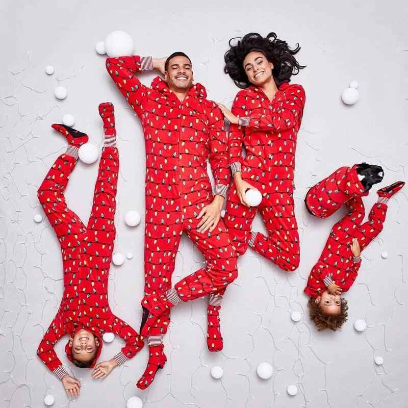 Matching family in red hooded Christmas pajama onesies with light bulb print - view 3