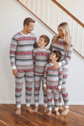Family wearing matching Fair Isle reindeer print Christmas pajamas with white cuffs