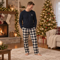 Matching holiday pajamas with checked plaid pants and dark long-sleeve tops - view 2