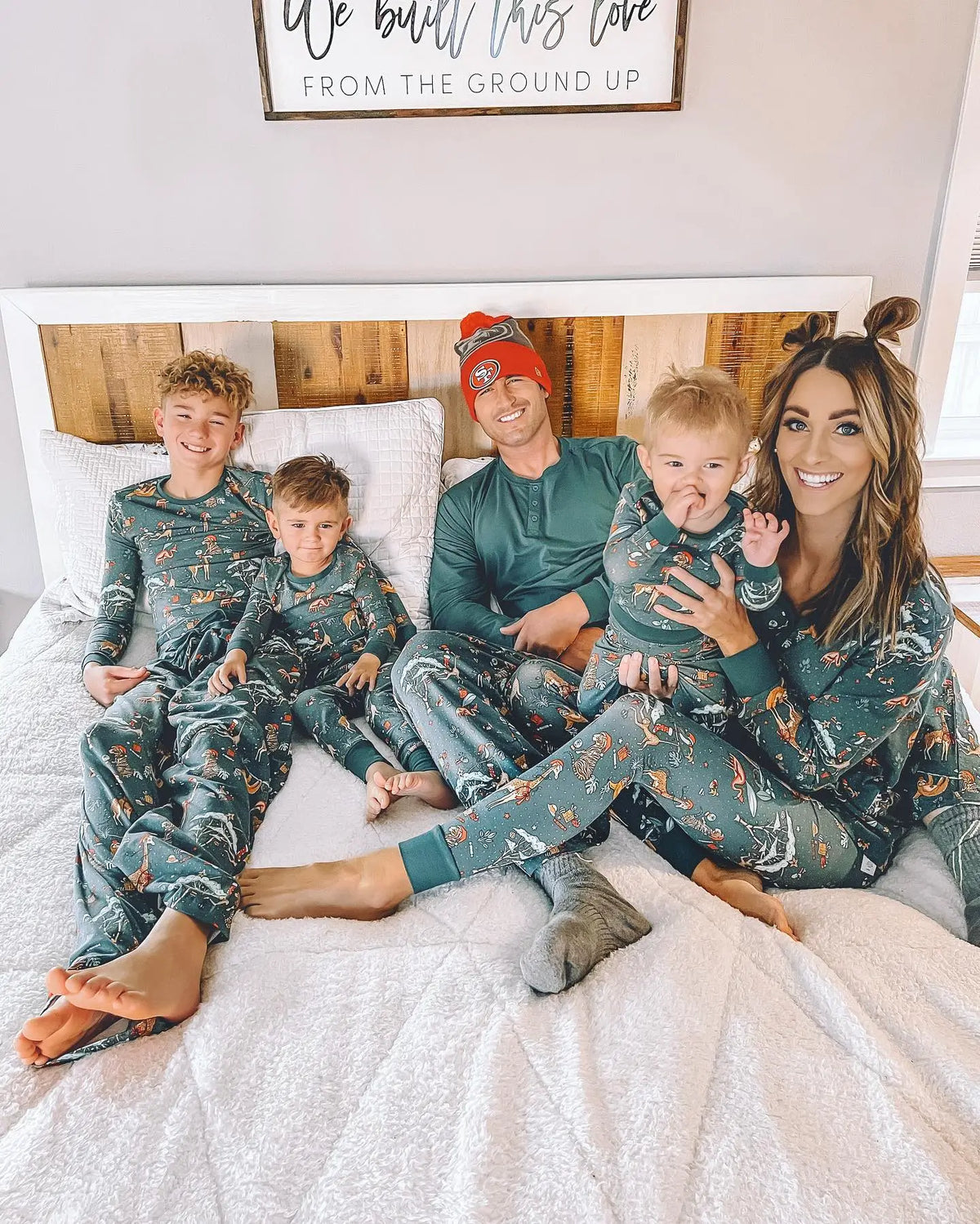 Family wearing matching green jungle animal print Christmas pajamas - view 15