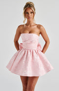Pink jacquard homecoming mini dress with strapless bodice, corset lacing and large back bow