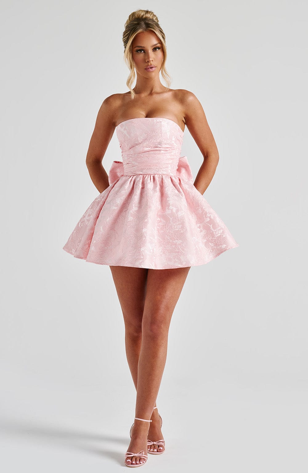 Pink jacquard homecoming mini dress with strapless bodice, corset lacing and large back bow - view 2
