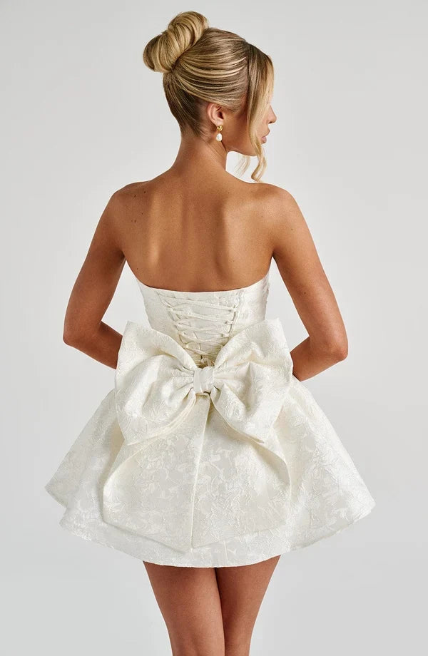 Pink jacquard homecoming mini dress with strapless bodice, corset lacing and large back bow - view 9
