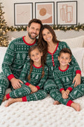 Matching family Christmas pajamas in green Fair Isle-style print with red cuffs