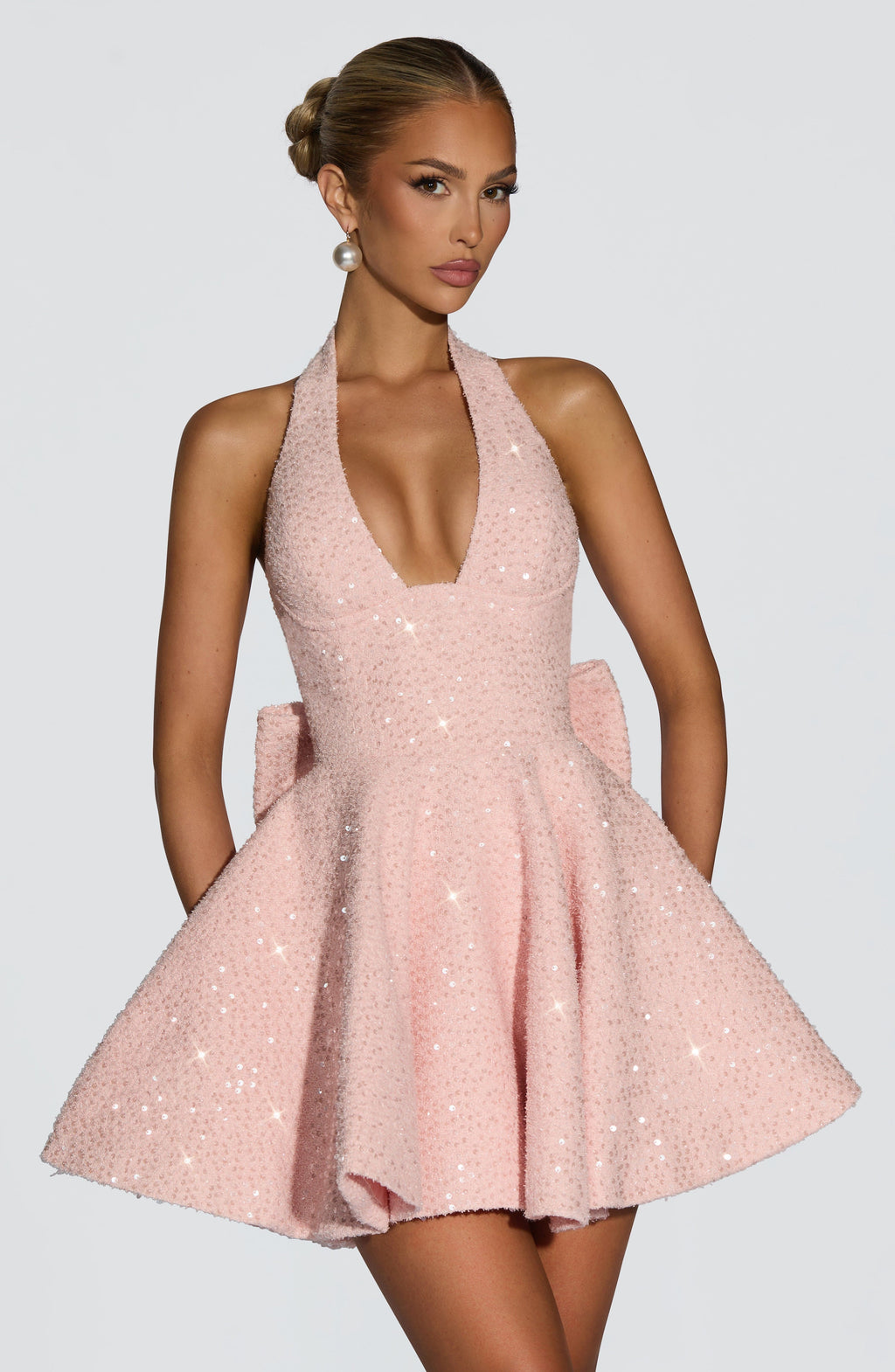 Sparkly pink halter mini dress with flared skirt and back bow