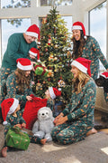 Matching family Christmas pajamas in green with festive safari animal print